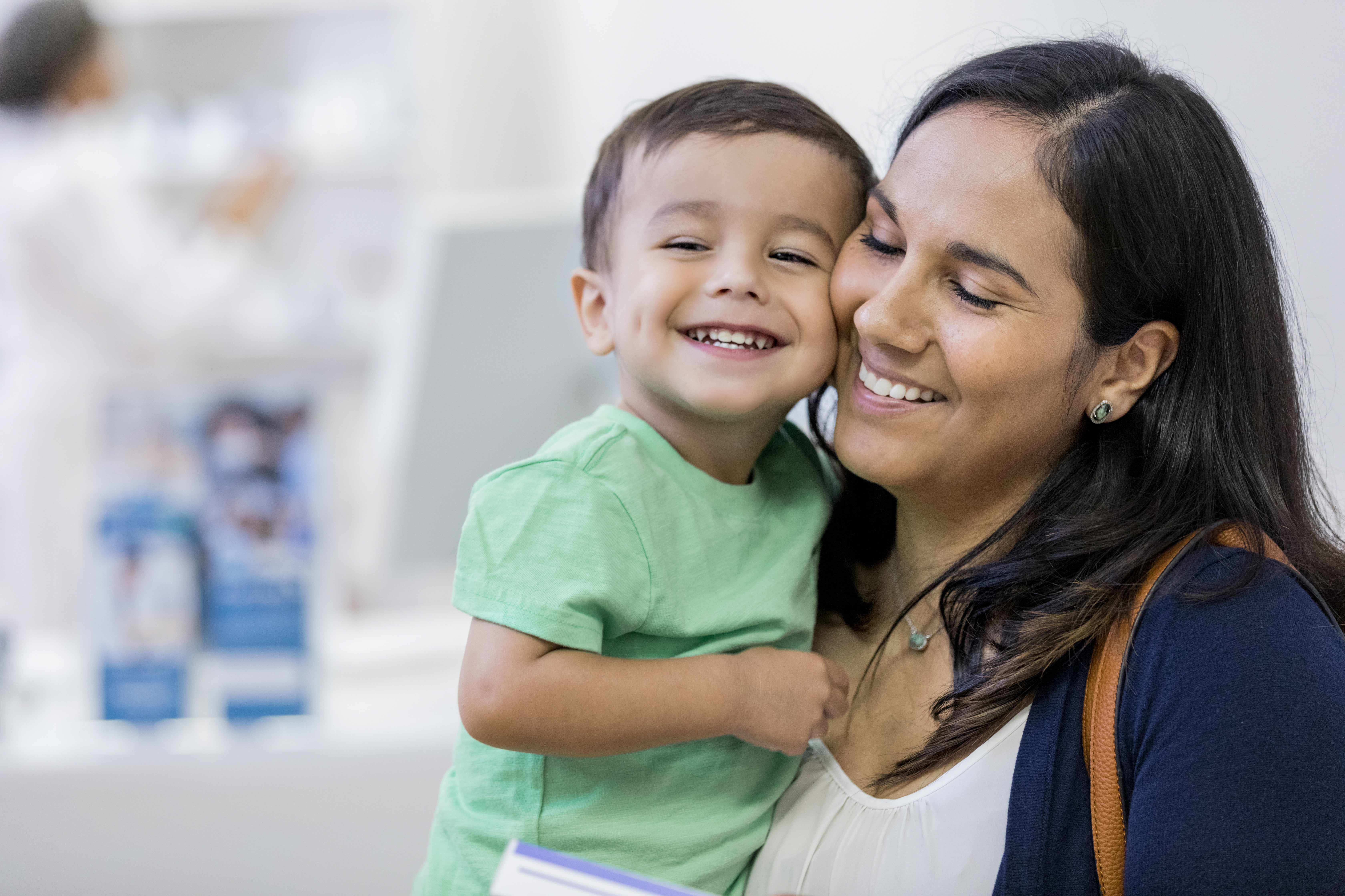 Woman holding a toddler boy in her arms